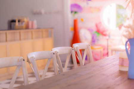 Empty wooden cafe table with flower vase for cafe restaurant backdrop and background.