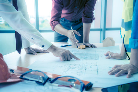 Construction team with business man engineer and architect is brainstorming on working table with...