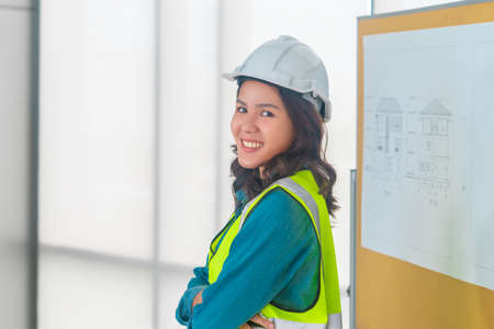 Attractive engineer woman with smile is standing in meeting room.の写真素材
