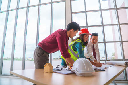 Construction team with business man engineer and architect is brainstorming on working table with copy space on sideの写真素材