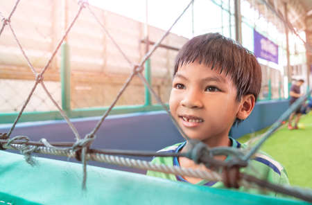 Portrait of an asian boy in Soccer uniform in an indoor soccer training pitch.の写真素材