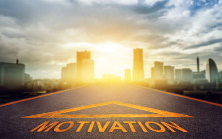 Motivation arrow road sign going to modern business city sunset for Success pathway conceptの写真素材
