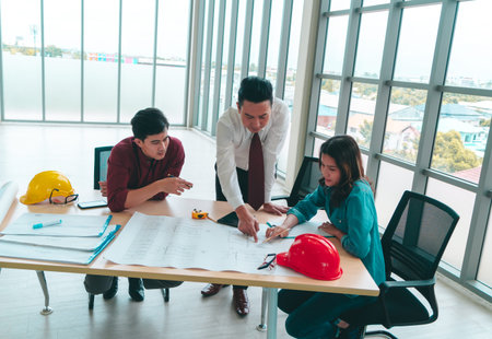 Construction Boss with business man engineer and architect is discussing on working table with...