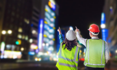 Two civil engineer team is looking at modern neon City for construction industry success concept.