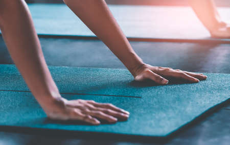 Human hands pushing up on a sport Yoga fitness matressの写真素材