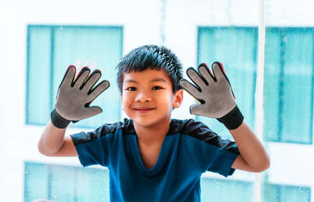 Happy soccer boy goalkeeper showing his football keeper glovesの写真素材