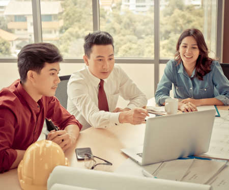 Three contractor builder team having a successful meeting in office.の写真素材