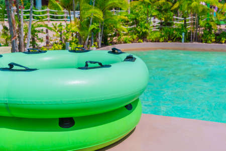 Large Green swim ring for water park slide on water park pool side.の写真素材
