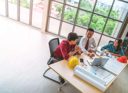 Three contractor builder team having a successful meeting in office with copy space.の写真素材