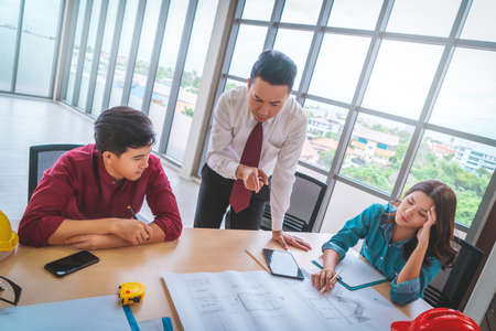 Angry Construction Boss is brainstorming with Engineer and Architect team in a Building contractor meeting.の写真素材