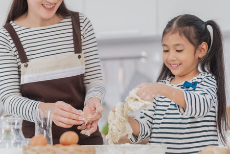 Mother and child working together to mix flour and ingredient for Cooking and Baking bakery in home...