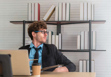 White Businessman looking out the windows with worrying face on office desk with copy space.の写真素材