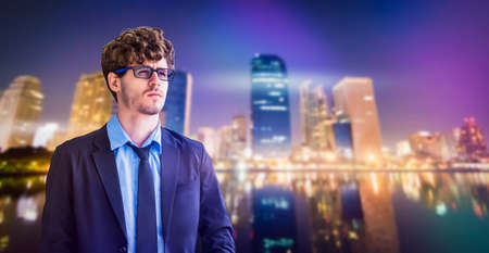 One Casual white Business man standing with determining face on a modern Bangkok city background.の写真素材