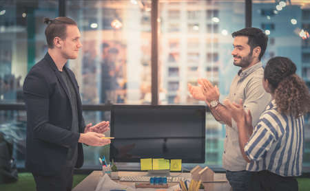 Three young start up business people is having a creative brainstorming meeting in a shared working space.の写真素材