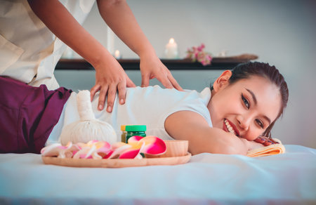 Female Masseur is giving Asian Female a Thai back massage in Thai Relaxing Spa Therapy.の写真素材