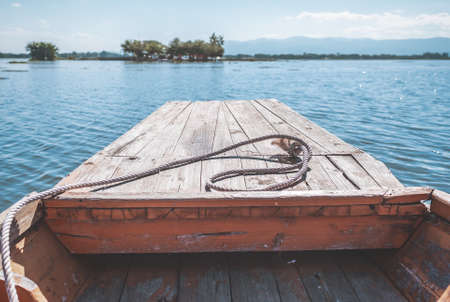 Boat Traveling in Lake heading to the shore front view with no people in Phayao Thailandの写真素材