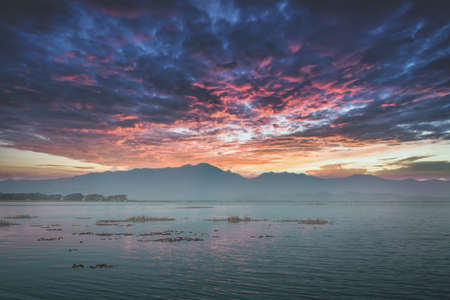 Dramatic sky setting in a mountain lake for natire background.の写真素材