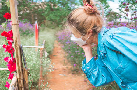 Asian girl is taking selfie photo wile traveling in a flower garden in vacation trip.の写真素材