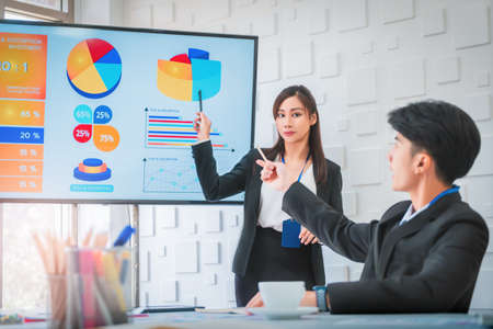 Confidence usiness woman is presenting Data on a Monitor in a meeting room for team mate.の写真素材