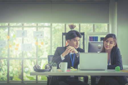 Two Business people is discussing work on notebook laptop in office with serious face.の写真素材
