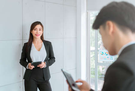 Portrait of an Asian Business woman Standing in the background for supporting role in meeting.の写真素材