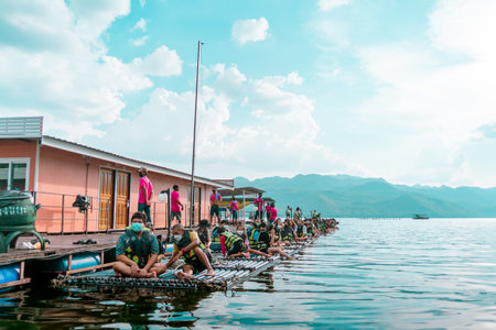 Kanchanaburi, Thailand - 20 April 2022 : People are getting on the Raft resort in Thai lake for Vaccationのeditorial素材