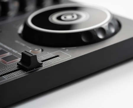 Digital DJ mixing deck Controller closed up on the BPM Tempo faderの写真素材