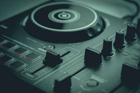 DJ mixing deck Controller connecting to Laptop and tablet using USB cable.の写真素材