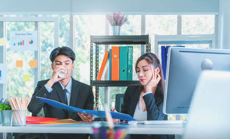 Office worker having a break by drinking coffee during work in the office.の写真素材