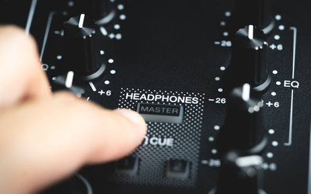 Digital DJ mixing deck Controller closed up on the Headphone Cue Button.の写真素材