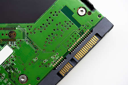 An internal Hardisk drive in 3.5 size isolated on white closed up on the SATA connection.の写真素材