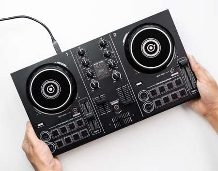 DJ is using the Digital DJ deck controller for Computer and Tablet, Top view.の写真素材