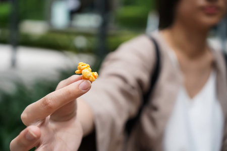 Woman holding popcorn cheese in a paper bag  in the hand