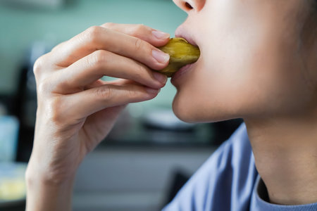 Asian woman is eating Sweet Potatoes, closed up shot.の写真素材