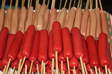 Hotdogs on sticks filed on the plate.の写真素材