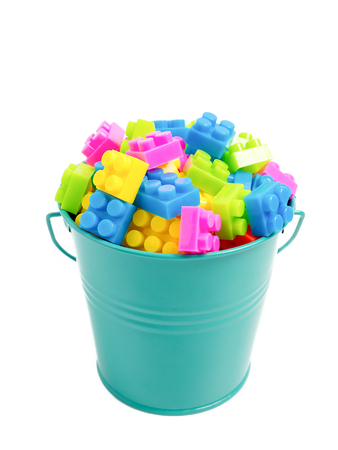 Plastic Building blocks - plastic construction in bucket colorful children's toy isolated on white backgroundの写真素材