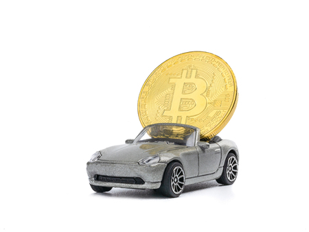 Bitcoins on the car model isolated on white background. view from above with text copy spaceの写真素材