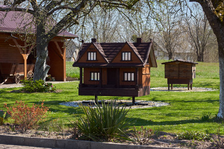 Wooden house in the garden. Spring in the city park.の写真素材