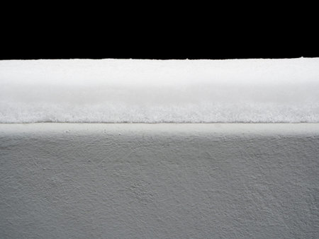 Grey wall covered with snow