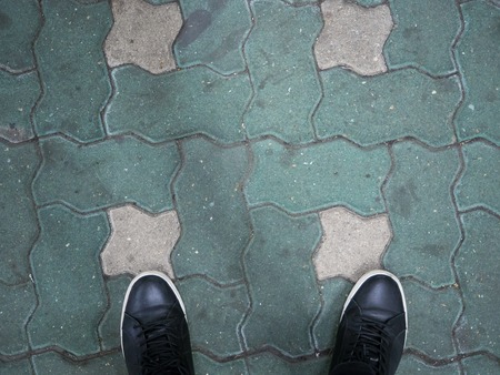 Top View of Black Shoes on Concrete Block Backgroundの写真素材