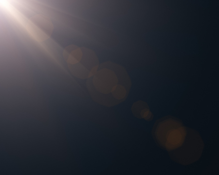 Realistic digital lens flare effects in black backgroundの写真素材