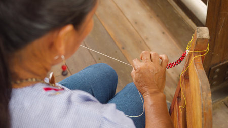Detail Shot Of Indigenous Woman Finishing A Seed Bracelet Top View Ecuador
