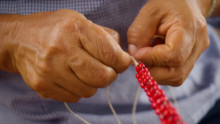 Detail Shot Of Indigenous Woman Making A Seed Necklace Ecuador
