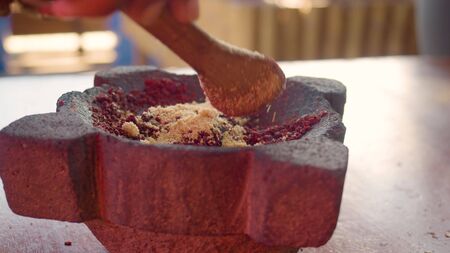 Detail Shot Of Hands Mixing Brown Sugar With Ground Cocoa In A Mortar In Ecuadorの写真素材