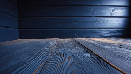 Low-angle shot of dark wood surface and wall, strong directional lightの素材