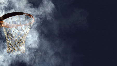 A basketball hoop, shrouded in smoky fog against a dark, diffused backgroundの素材