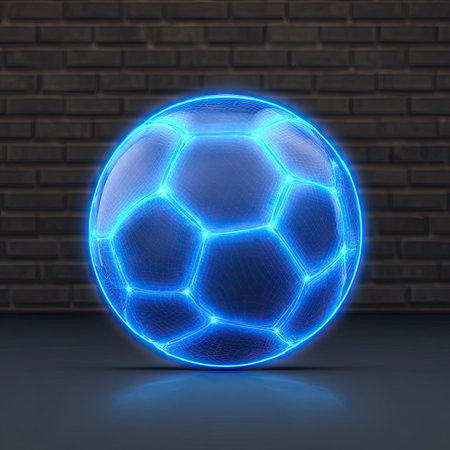 A digitally rendered soccer ball glows with neon blue light. The transparent sphere features hexagonal patterns, contrasting with a dark surface and a textured brick wall. The composition emphasizes a vibrant, futuristic aesthetic, suitable for diverse conceptual projects or visual marketing content.の素材
