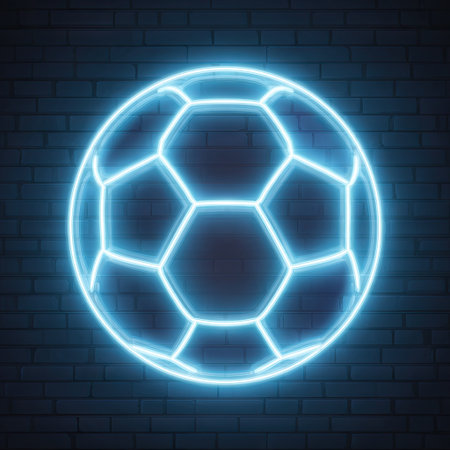 A neon-style soccer ball is presented against a dark brick wall. The image features a glowing, light blue ball with hexagonal segments, highlighting the geometric design. The textured brickwork offers a contrasting backdrop. This image can be used in digital media, advertising, and design projects.の素材