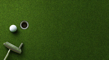 A golf ball sits next to a hole with a putter resting on the edge of a green surface. The scene is illuminated with soft lighting. This image showcases a professional golf setup and may be used in various media. It features ample copy space.の素材