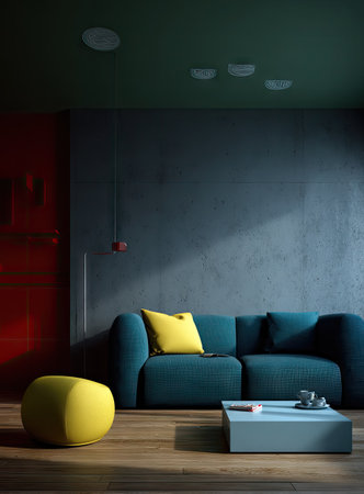 This interior showcases a teal sofa and a yellow cushion and ottoman, creating a modern living space. The scene features a low table and a textured wall bathed in soft lighting. This imagery is suitable for use in advertising or editorial designs, offering a visual representation of comfort and contemporary living.の素材